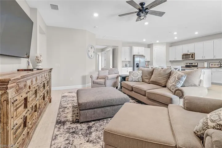 Living room with ceiling fan and light wood-type flooring
