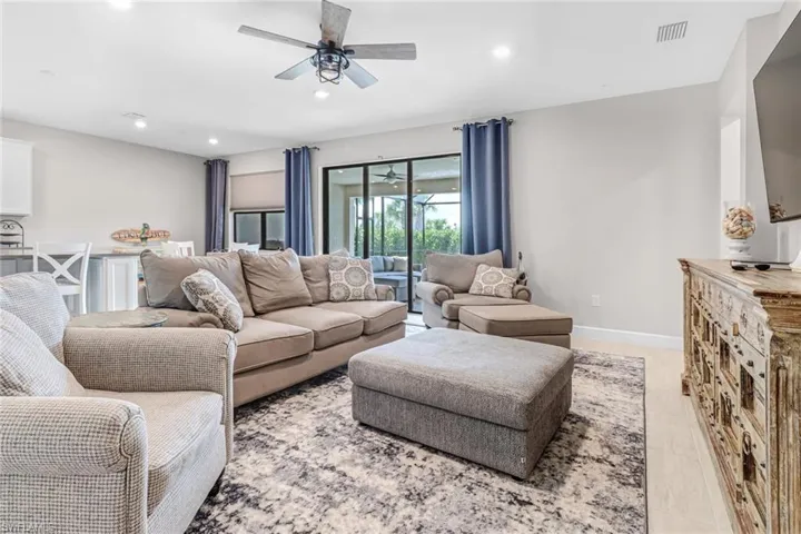 Living room featuring ceiling fan and wood-type flooring