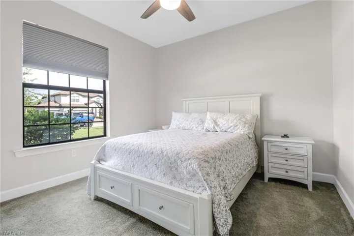 Carpeted bedroom with ceiling fan