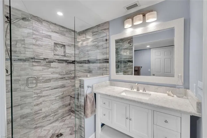 Bathroom featuring vanity, a stall shower, and recessed lighting