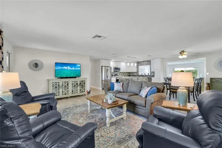 Living room with wood finished floors and a ceiling fan
