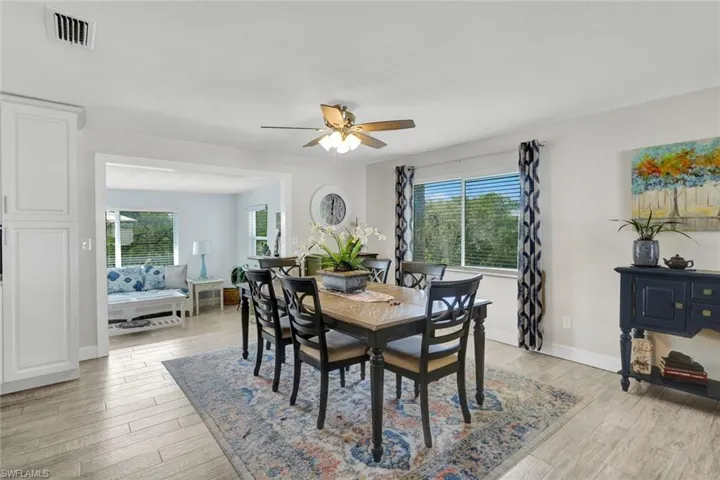 Dining space with light wood-style flooring, healthy amount of natural light, and ceiling fan