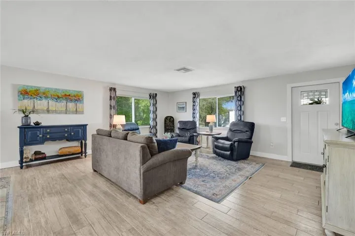 Living area featuring light wood-style flooring and baseboards
