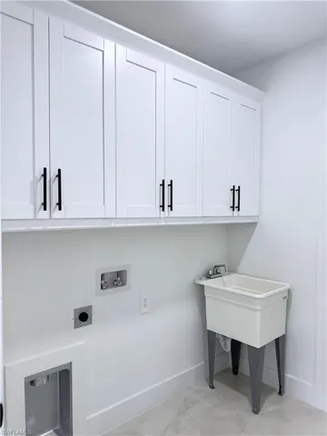 Laundry area featuring cabinet space, washer hookup, and electric dryer hookup