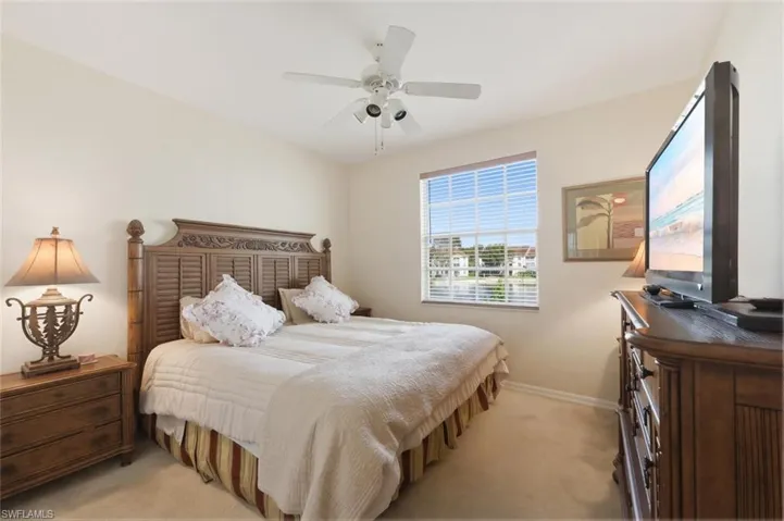 Bedroom featuring light colored carpet and ceiling fan