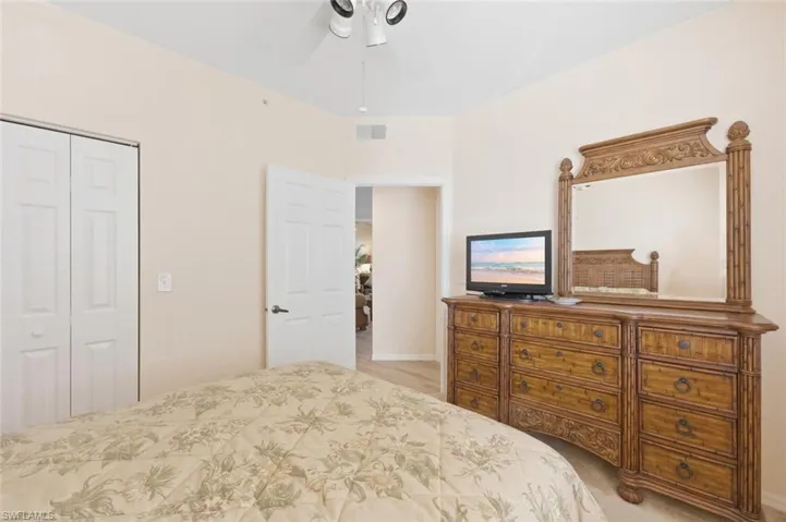 Bedroom with ceiling fan and a closet