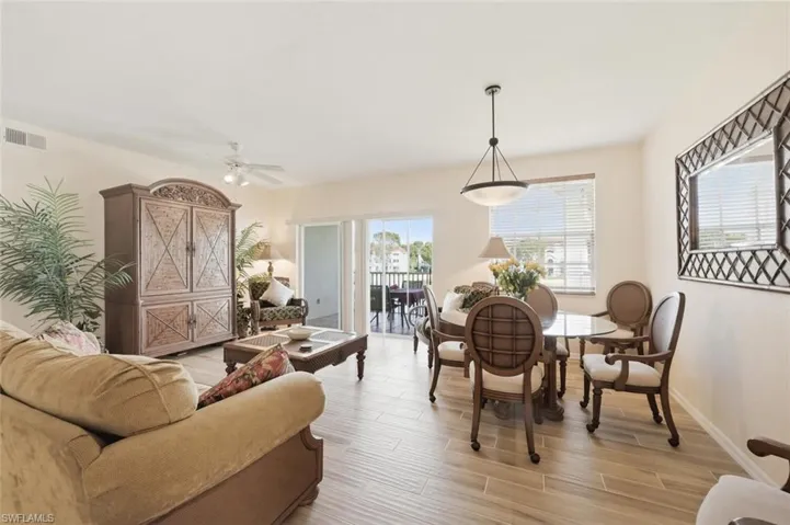 Dining space featuring wood tiled floors and a ceiling fan