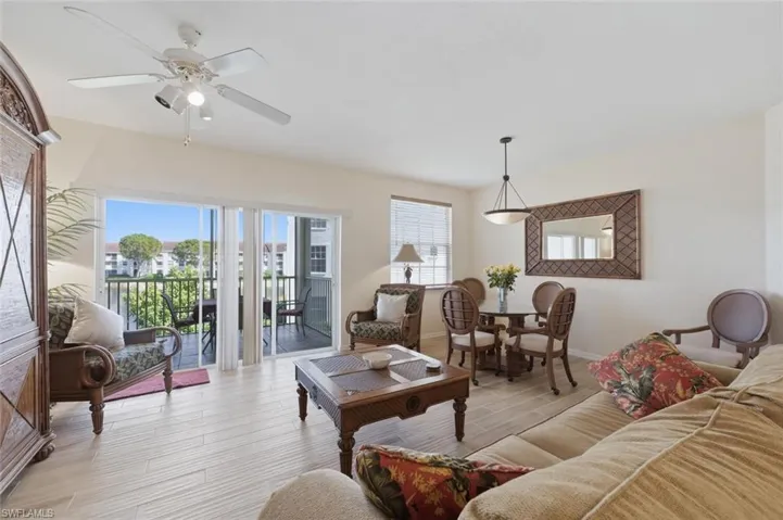 Living area with wood finished floors and ceiling fan