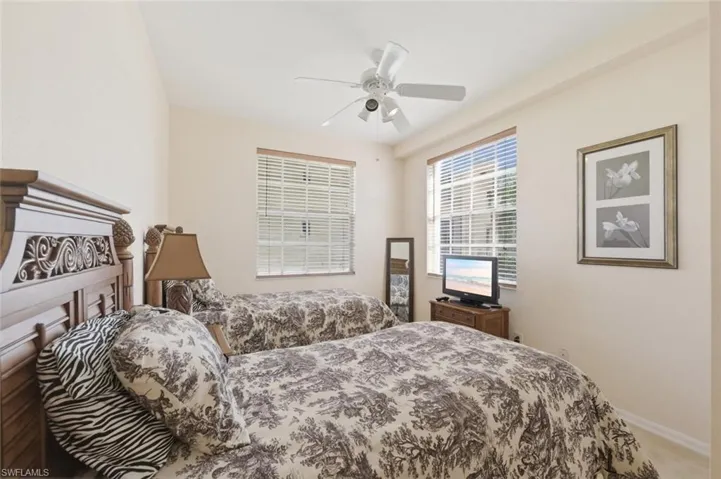 Bedroom featuring ceiling fan and light colored carpet