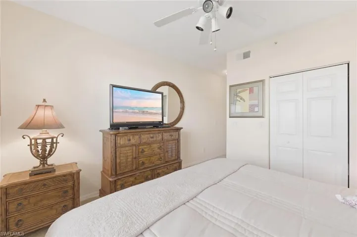 Bedroom featuring a ceiling fan and a closet