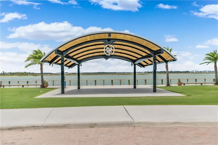 View of property's community featuring a water view and a yard