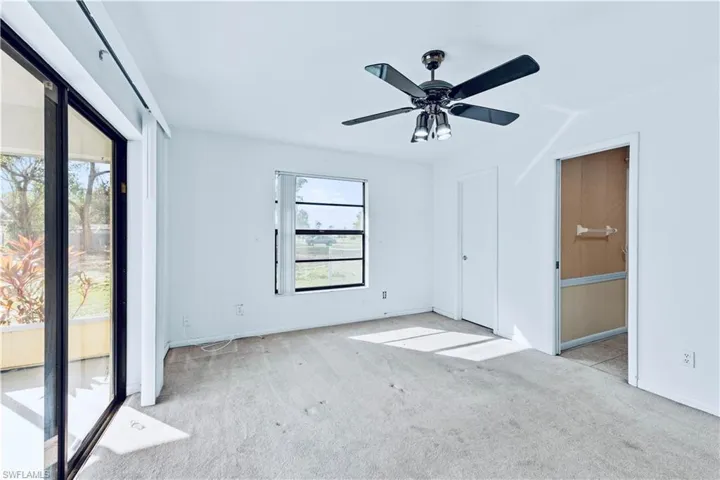 Unfurnished room featuring light carpet and ceiling fan