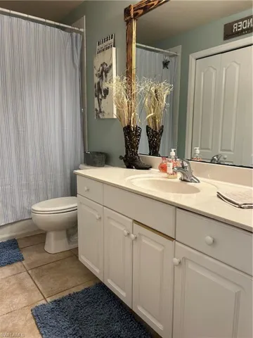 Bathroom featuring vanity, tile floors, and a shower tub combo.