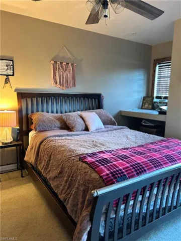 Bedroom featuring carpet flooring, ceiling fan.