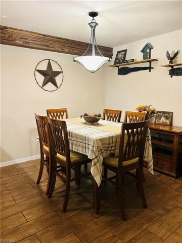 Dining space with wood plank tile floors.