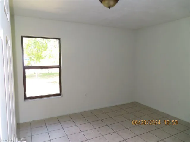 Unfurnished room with light tile patterned flooring
