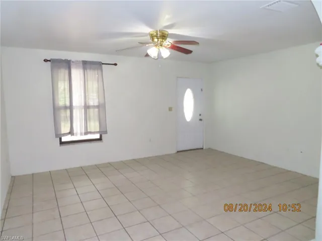 Foyer entrance featuring light tile patterned floors, a wealth of natural light, and ceiling fan