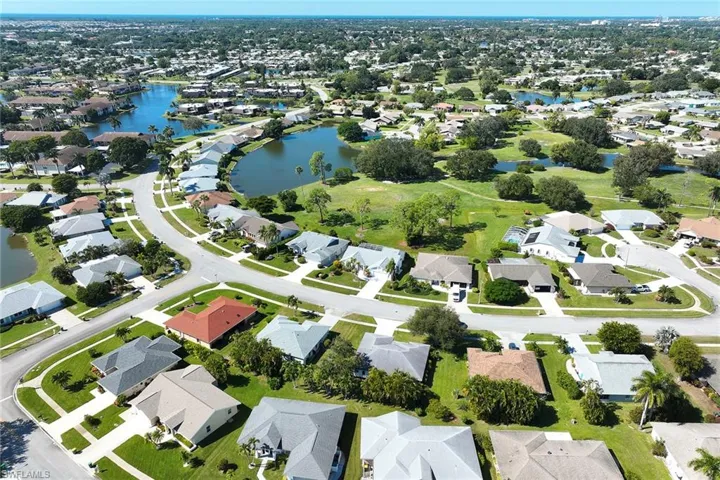 Aerial view of property's location with a nearby body of water and nearby suburban area