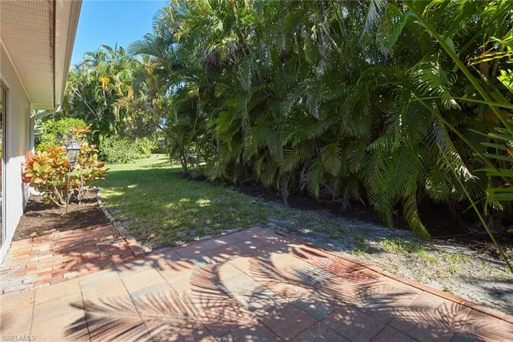 View of green lawn featuring a patio