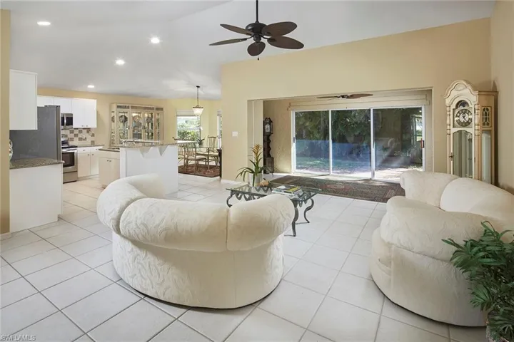 Living room featuring recessed lighting, light tile patterned flooring, vaulted ceiling, and ceiling fan
