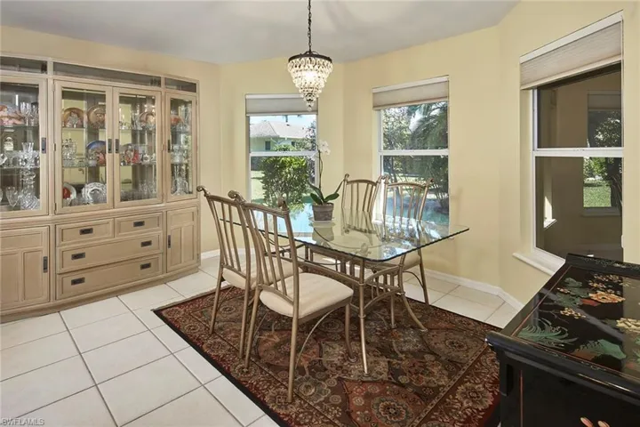 Dining area featuring light tile patterned flooring and a chandelier