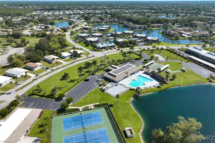 Aerial view of property and surrounding area with a large body of water and nearby suburban area