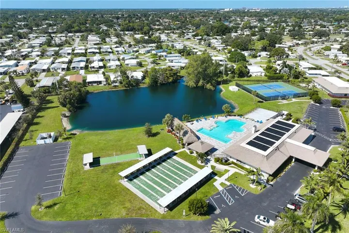 Bird's eye view of a pool area and a nearby body of water
