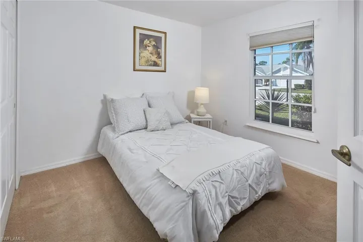 Carpeted bedroom featuring baseboards