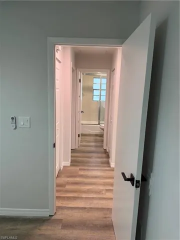 Hall featuring wood finished floors and baseboards
