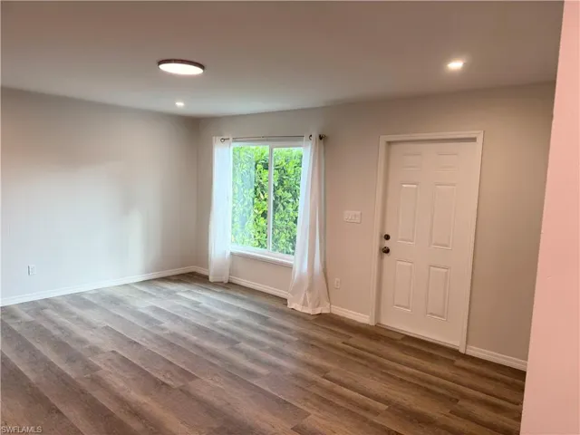 Foyer entrance featuring wood finished floors and recessed lighting