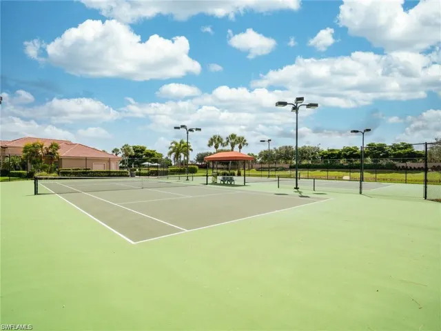 View of tennis court with a gazebo