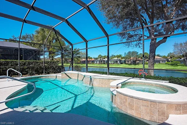Combined pool / hot tub with a water view, a residential view, a sunroom, a lanai, and a patio