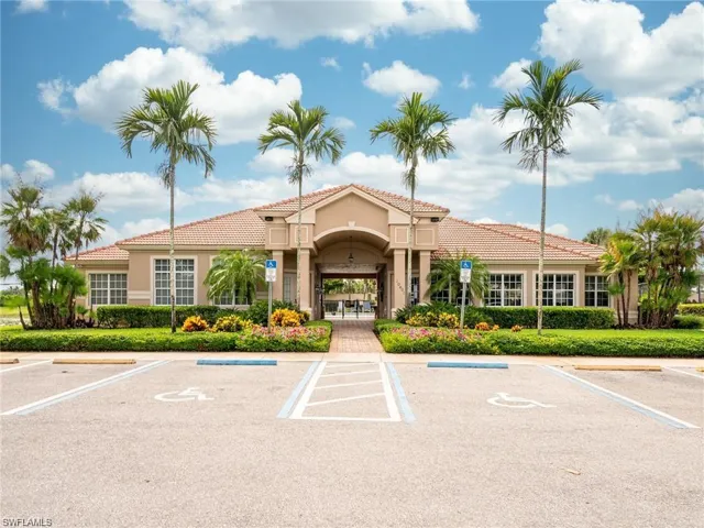 View of property featuring uncovered parking