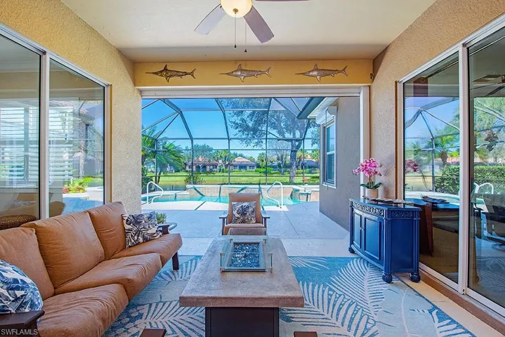 View of patio / terrace featuring a sunroom, an outdoor pool, a lanai, and a ceiling fan