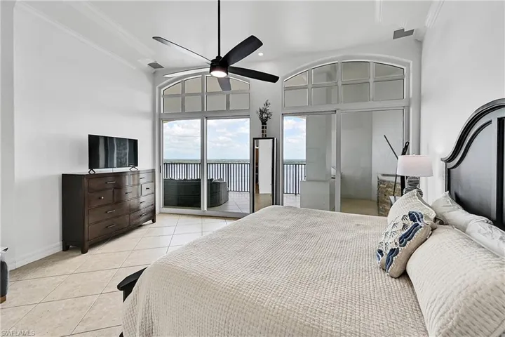 Bedroom featuring access to outside, light tile patterned floors, ornamental molding, baseboards, and a ceiling fan