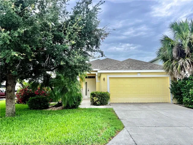 View of front of house with a garage and a front lawn