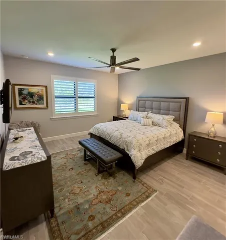 Bedroom with light wood-style floors, recessed lighting, and ceiling fan