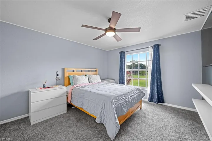 Bedroom with baseboards, carpet, and ceiling fan
