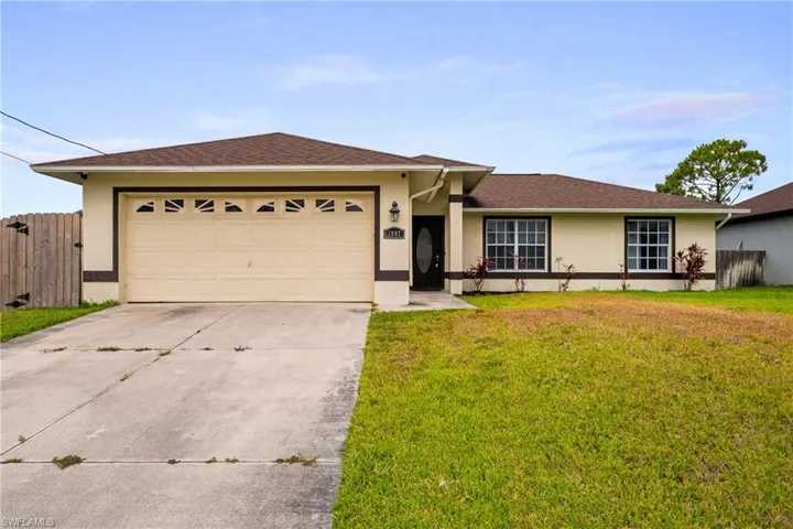 Ranch-style house featuring stucco siding, concrete driveway, and an attached garage