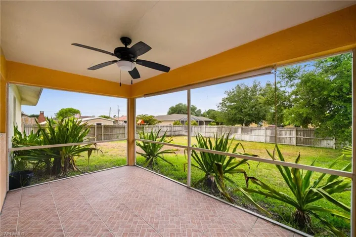Unfurnished sunroom with ceiling fan and healthy amount of natural light