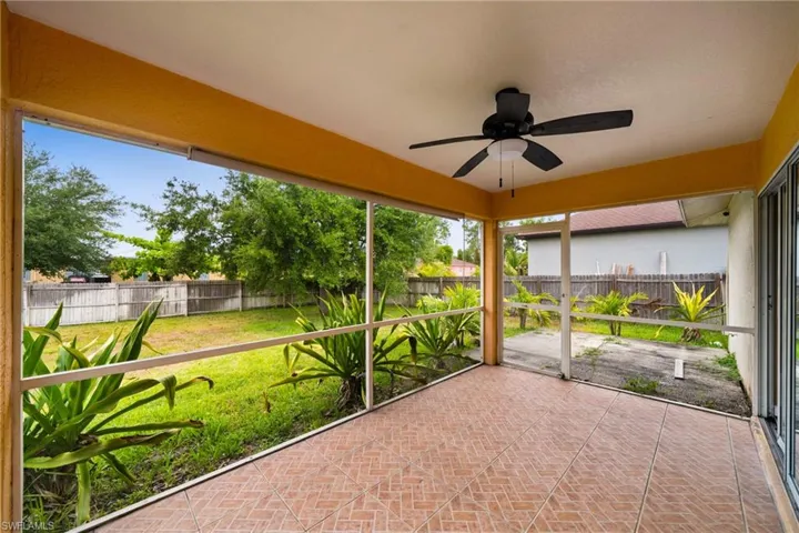 Unfurnished sunroom featuring ceiling fan