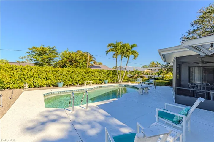View of pool with a patio and a sunroom