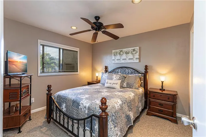 Carpeted bedroom with ceiling fan