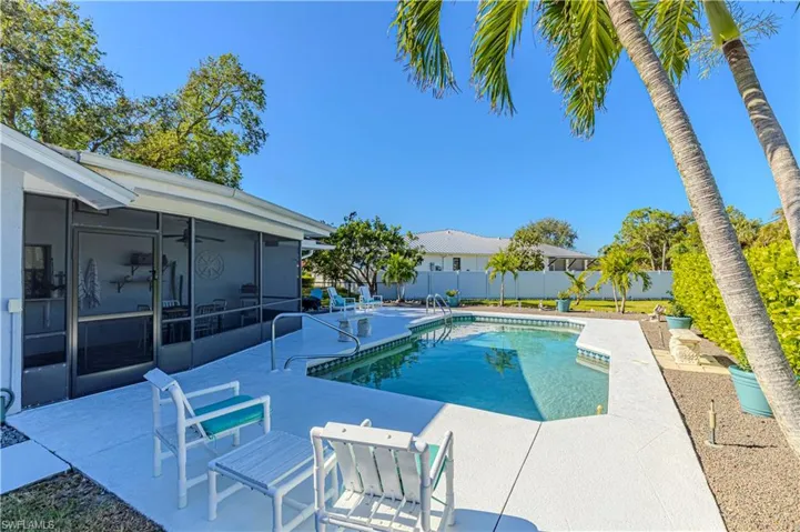 View of swimming pool with a sunroom and a patio