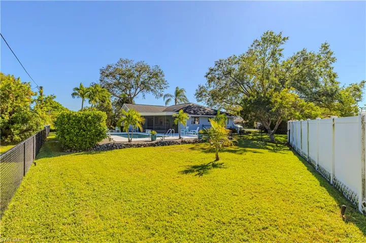 View of yard with a fenced in pool and a patio
