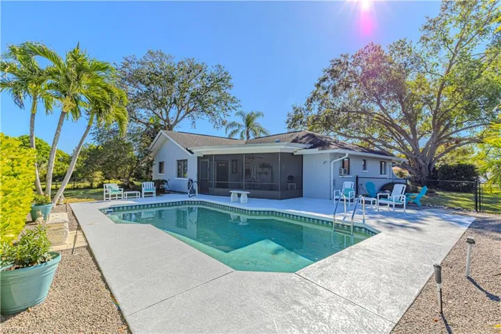 View of pool featuring a patio area, a sunroom, and ceiling fan