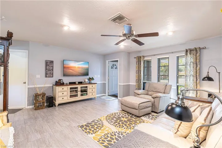 Living room featuring ceiling fan and light hardwood / wood-style floors