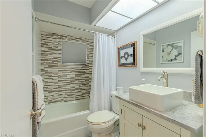 Full bathroom featuring vanity, shower / bath combo