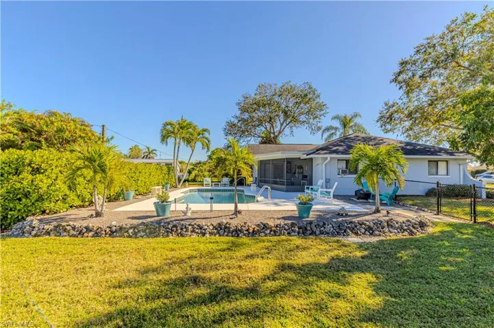View of swimming pool featuring a lawn, a sunroom, and a patio