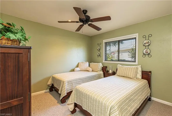 Carpeted bedroom with ceiling fan